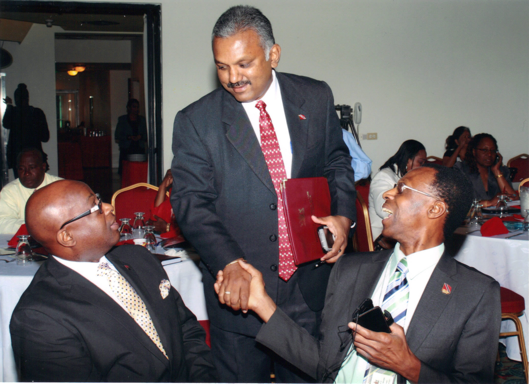Honourable Rudranath Indarsingh greets Permanent Secretaries Mr. Carl Francis (left) and Mr. Reynold Cooper (right) 