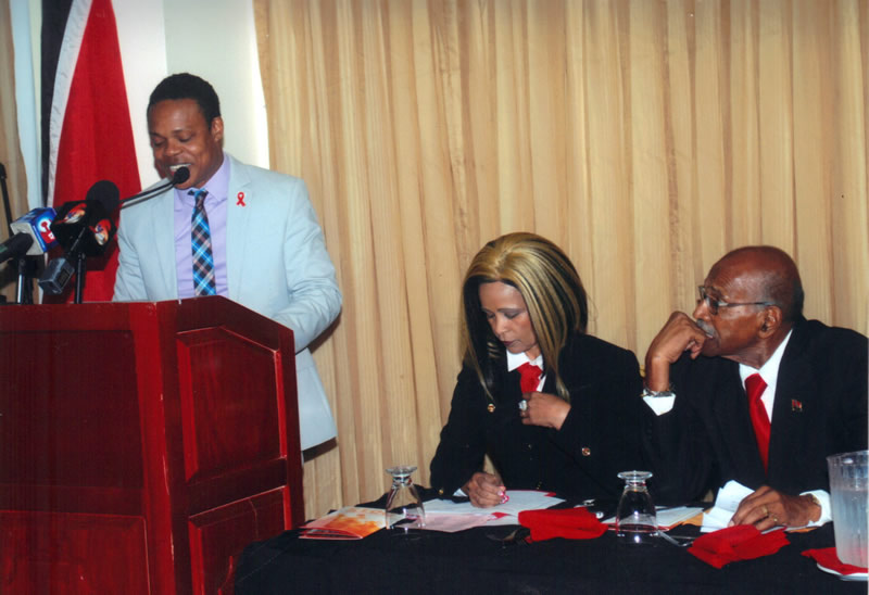 Dr. Amery Browne delivers the Feature Address while League Chief Operating Officer, Dianne Joseph and Vice President Desmond Baxter listens.