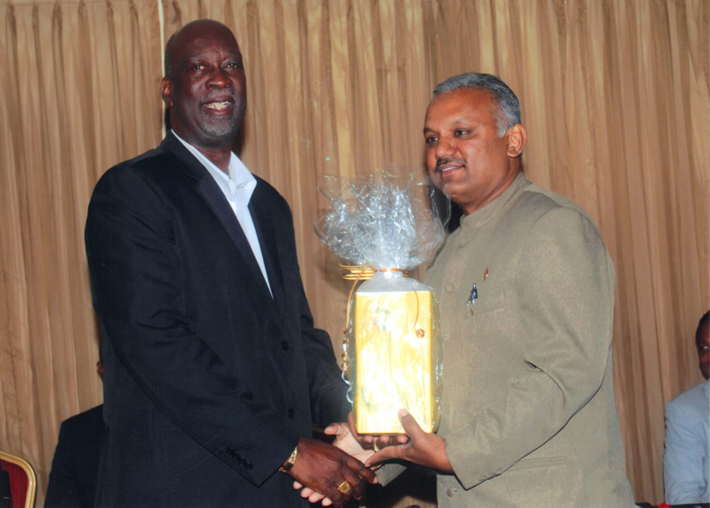 Honourable Rudranath Indarsingh (right) receives a token of appreciation, from League President, Joseph Remy.